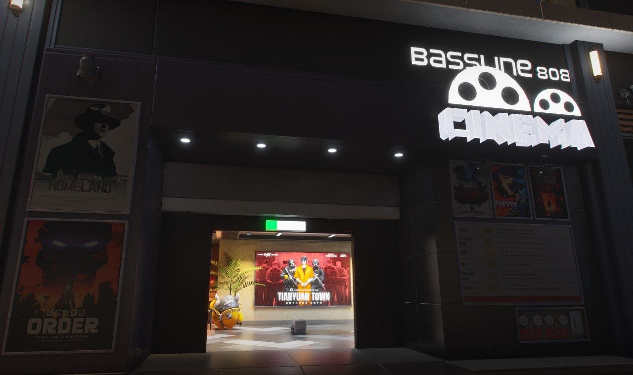 Ночной вход в кинотеатр Bassune 808 Cinema с подсвеченной вывеской и постерами фильмов в Ananta